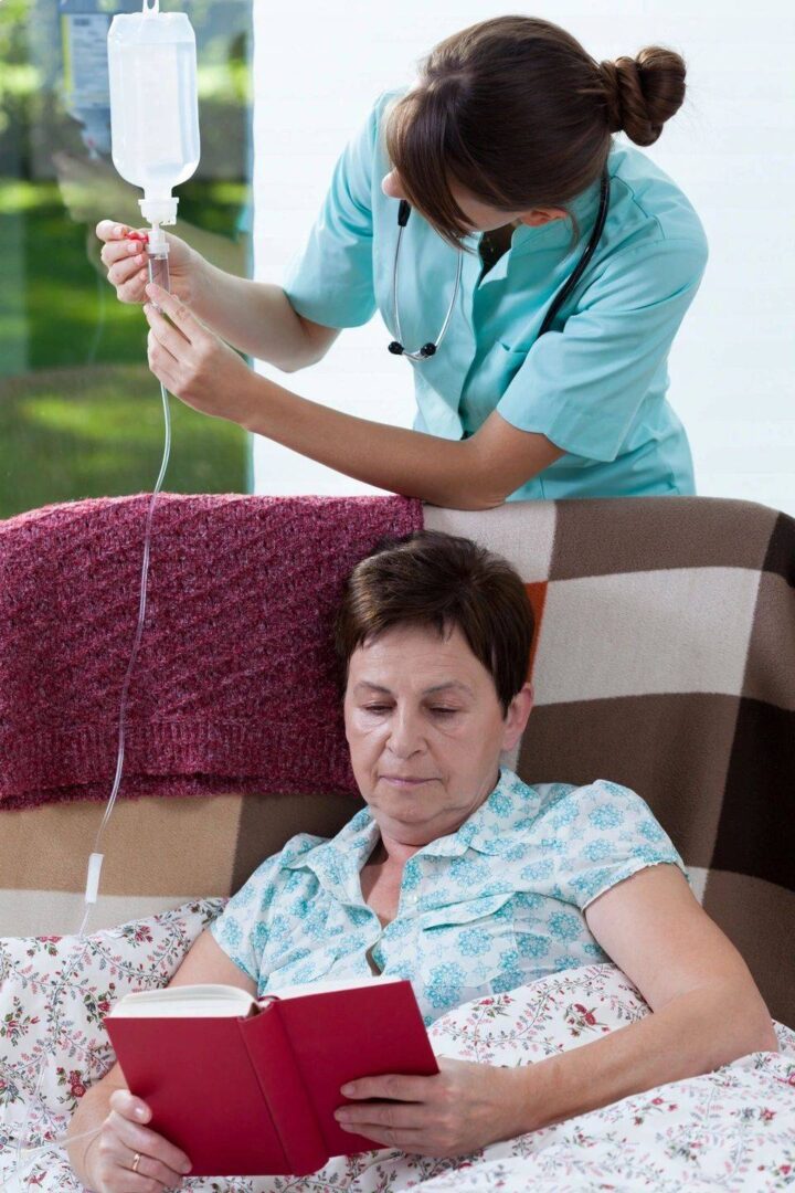 A nurse is checking the heartbeat of an older woman.