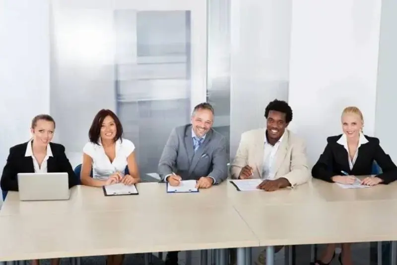 A group of people sitting at a table.