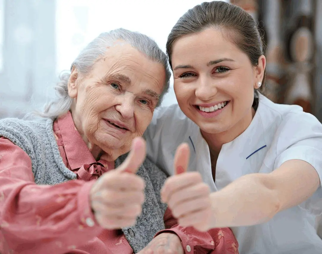 A woman and an old lady giving thumbs up